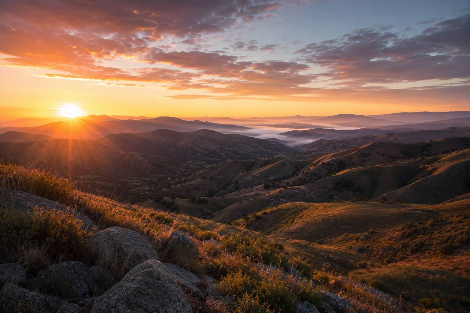 Dawn light breaking over California hills